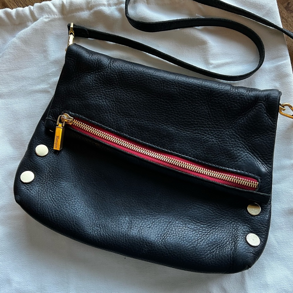 Hammett VIP fold over Crossbody bag in gunmetal black with red.